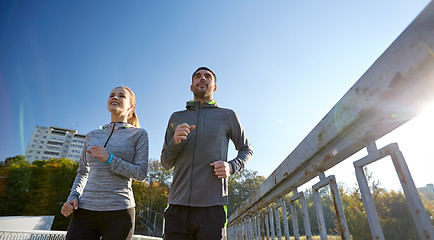 Image showing happy couple running outdoors