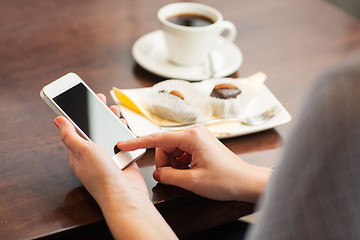 Image showing close up of woman with smartphone and dessert