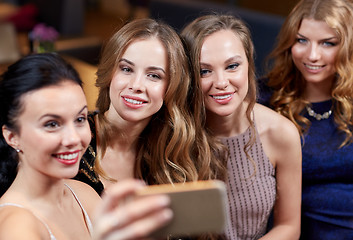 Image showing women with smartphone taking selfie at night club