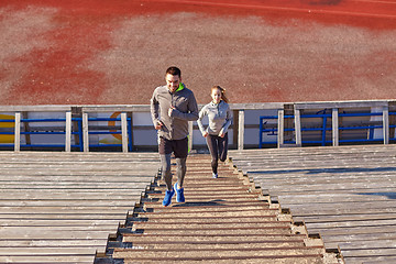 Image showing happy couple running upstairs on stadium