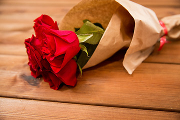 Image showing close up of red roses bunch wrapped into paper