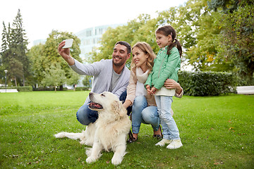 Image showing happy family with dog taking selfie by smartphone