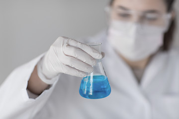 Image showing close up of woman with flask making test in lab