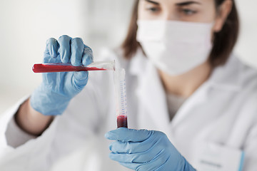 Image showing close up of scientist with tube making test in lab