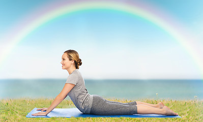 Image showing woman making yoga in dog pose on mat