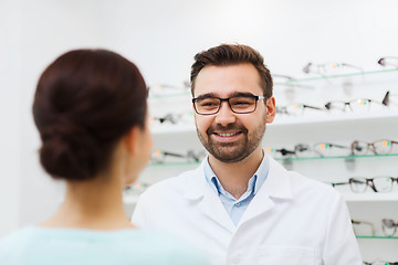 Image showing woman and optician in glasses at optics store