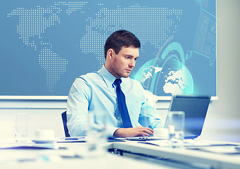 Image showing businessman with laptop working in office