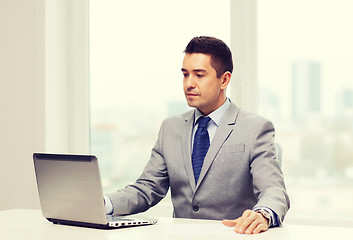 Image showing businessman working with laptop in office