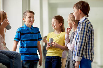 Image showing group of school kids with soda cans in corridor