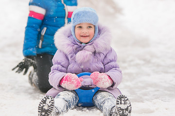 Image showing Five-year girl rolled down ice slides looked up