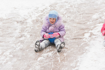 Image showing  Five-year girl in the middle of the ice slides slides