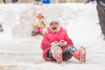 Image showing Joyful child rolls a seven-year ice slides