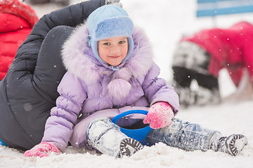 Image showing Five-year girl rolled down a hill sits 