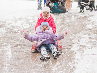 Image showing Two cheerful girls ride a roller coaster of ice