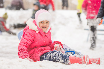 Image showing Joyful seven-year child rolled down a hill