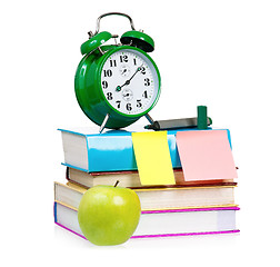 Image showing  Big green alarm clock with books and apple 