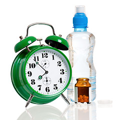 Image showing Big alarm clock with bottle of water and pills