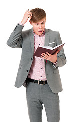 Image showing Man in suit looking very shocked with notepad