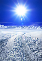 Image showing Snow covered road and sun