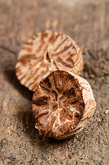 Image showing Nutmeg on wooden table