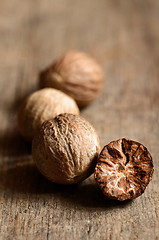 Image showing Nutmeg on wooden table