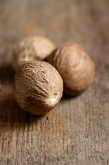 Image showing Nutmeg on wooden table