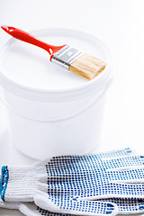 Image showing paintbrush, paint pot and gloves