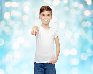 Image showing happy boy in white t-shirt pointing finger to you