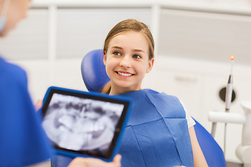 Image showing dentist with x-ray on tablet pc and girl patient