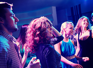 Image showing smiling friends dancing in club