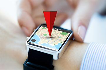 Image showing close up of hands with map on smartwatch screen