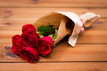 Image showing close up of red roses bunch wrapped into paper