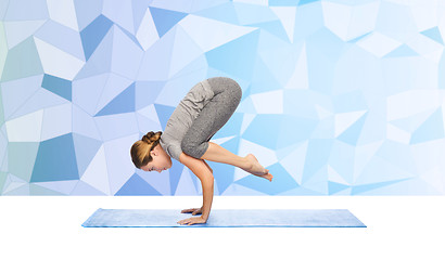 Image showing woman making yoga in crane pose on mat