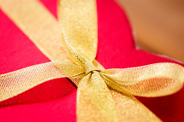 Image showing close up of red heart shaped gift box with bow