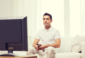 Image showing man with remote control watching tv