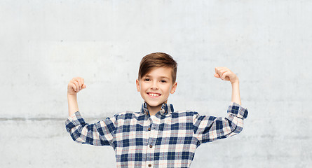 Image showing happy boy in checkered shirt showing strong fists