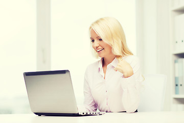 Image showing smiling businesswoman or student with laptop