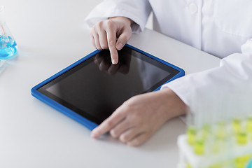 Image showing close up of scientist with tablet pc in lab