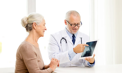 Image showing smiling senior woman and doctor with tablet pc