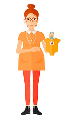 Image showing Pregnant woman with clothes for baby.