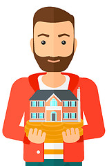 Image showing Man holding house model.