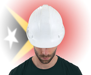 Image showing Engineer with flag on background - East Timor