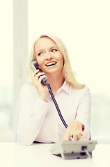 Image showing smiling businesswoman or student calling on phone