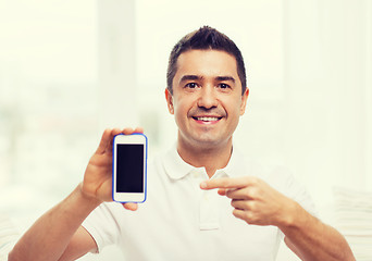 Image showing happy man with smartphone at home