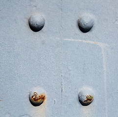 Image showing blue   handle in london antique  door  rusty  brass nail and lig