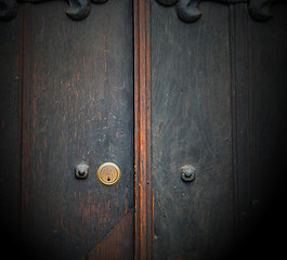 Image showing handle in london antique brown door  rusty  brass nail and light