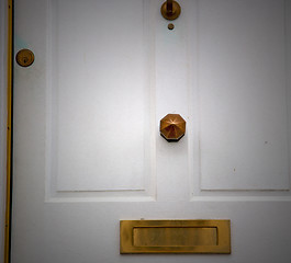 Image showing handle in london antique brown door  rusty  brass nail and light