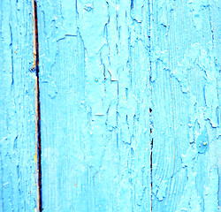 Image showing dirty stripped paint in the blue wood door and rusty nail