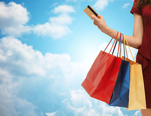 Image showing close up of woman with shopping bags and bank card