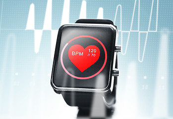 Image showing close up of black smart watch with heart beat icon